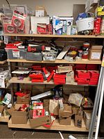 Overall view of shelves holding various boxed and loose hardware items including weather stripping, window glazing, crayons, glue, chalk, and other supplies.
