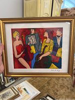 Close-up of framed serigraph featuring four musicians with string instruments, signed by Linda Le Kniff.