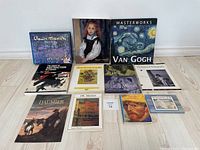 Front view of eleven art books including titles by Renoir, Van Gogh, Monet, Canadian abstraction and photography.
