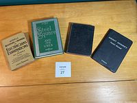 All four vintage technical books laid flat side by side showing covers and seller lot number card.