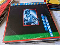 Photo showing the Lee Ritenour First Course vinyl record album cover featuring a photo of Lee Ritenour with guitar. Edges show minor wear.