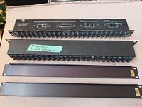 Two rackmount TRS patch bays stacked showing the top one with silkscreen normaling diagrams and the bottom with a label indicating model and instructions.