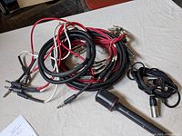 Overview of all cables and microphone together showing variety of connectors and brands