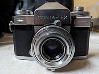 Front view of the Contaflex camera showing the Carl Zeiss 50mm f/2.8 Synchro-Compur lens with serial number.