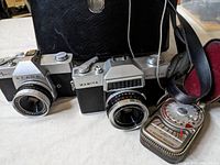 Mamiya Auto-Lux 35 and Sears Auto 35 TL cameras alongside a light meter and black carrying case