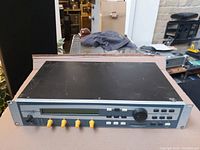 Front angle view of Creamware Noah synthesizer with control knobs, display and buttons on front panel, placed on a cardboard surface.