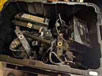 Close-up of Apollo SP-1500 II spotlight and assorted mounts inside plastic bin