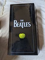 Photo of black Beatles box set with green apple on the front