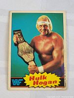 Front side of 1985 WF Hulk Hogan wrestling card showing full color image of Hogan holding championship belt with WF logo and name.