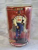 Front view of Dale Earnhardt Jr. NASCAR action figure in packaging.