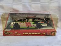 Front side view of Dale Earnhardt Jr. #88 NASCAR model car in clear display case, showing decals and packaging.