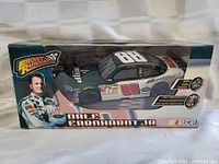 Photo of boxed remote control car featuring Dale Earnhardt Jr. #88 NASCAR vehicle by Front Runner, showing front and driver side with packaging in background.