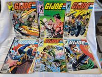 Six G.I. Joe comic books arranged in two rows of three, showing cover art and condition including creased and folded corners
