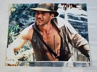 Full view of the signed photo showing Harrison Ford in character.