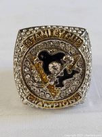 Front view of the replica Stanley Cup championship ring showing the Pittsburgh Penguins emblem and rhinestones.