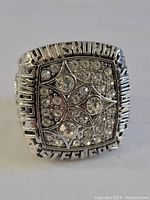 Front angle view of the Pittsburgh Steelers replica football ring showing the rhinestone encrusted face and raised text.