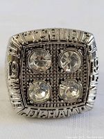 Front view of the replica ring showing 'Pittsburgh 1974 Champions' text and four clear stones on top.