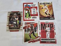 Five Tom Brady football cards laid out on white background showing front designs.