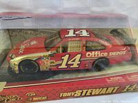 Side view of boxed Tony Stewart No. 14 NASCAR model car showing sponsor decals and packaging details.