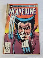 Front cover of Wolverine comic book showing character with claws and middle finger raised, some damage visible on edges and corners