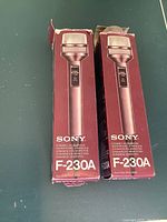 Photo showing two Sony F-230A microphones in original red boxes, unopened.