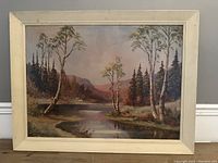 Frontal view of the framed oil on board landscape painting, showing the river, trees, and mountain scenery.