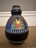 Front view showing overall shape and colorful geometric design on Gouda Holland vase.