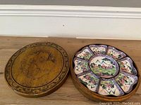 Top view of enamel server nestled in carved gilt wooden box lid removed