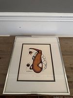 Framed First Nations lithograph titled "Pelican" showing full artwork and frame.