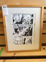 Framed original graphic novel page layout sheet showing three comic panels with characters and a forest scene in black and white ink