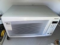 Full view of the Panasonic microwave showing front, door, and control panel.