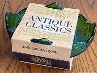 Jeannette Glass Co. #3435 Lombardi green glass bowl in original Antique Classics box, angled view of box and bowl edges.