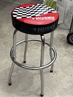 Full view of the Husky garage work stool showing vinyl top and chrome legs.