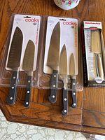 Top view showing all six knives in packages from Cooks and KitchenAid.