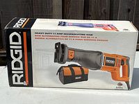 Box packaging containing Ridgid R3001 heavy duty 11 amp reciprocating saw and carrying bag shown from multiple angles to highlight product details.