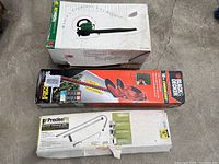 Three boxed items: gas blower, Black & Decker cordless hedge trimmer, PreciseFit gutter cleaner kit