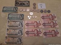 Overview of all paper banknotes and coins on table