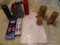 Overview of various candles including colored tapers, boxed character wax tapers, golden candles with star holders, and storage organizer.