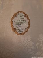 Close-up photo of original label showing 'Pure Irish Linen made expressly for Silbro's, the home of Irish linens.' Label includes measurements and pattern info.