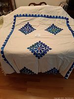 Full view of the rectangular table cloth laid over a table showing overall size and design