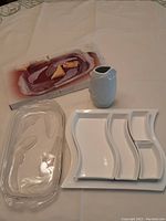 Lot showing all three items: clear crystal tray, white vase, and white appetizer tray with four sections.