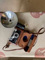 Argus C3 camera in leather case with flash attachment, top view