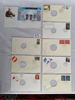 Nine Canadian sports-related First Day Issue Covers laid out on fabric, showing stamps, cancellations, and cutout circle designs.