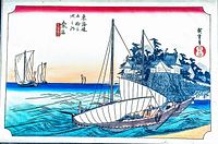 Close-up of woodblock print showing sailing boat on water with buildings and trees in the background, Japanese text and stamps