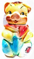 Front view of the vintage American bisque farmer pig cookie jar, showing colorful glaze and detailed facial features.