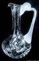 Full view of clear art glass water pitcher with frosted twisted handle showing its size and shape