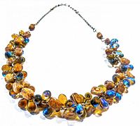 Front view of iridescent art glass necklace showing multi-colored beads on chain