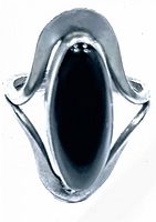 Top view of the sterling silver ring with black onyx stone, highlighting the oval black onyx centerpiece and silver wave mounting.