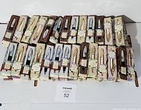 Overview of approximately 40 boxed personalized pens arranged in rows showing the pen styles and packaging.