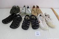 Top view of seven pairs of women's shoes including sneakers and water shoes, various colors and brands, showing overall condition and color details.